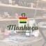 Logótipo do Manhuço sobre fotografia da loja do Manhuço em Chaves